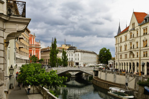 Ljubljana, Slovenia --- Historic architecture lines the Ljubljanica River in the city center with the Tromostovje bridge, also known as Triple Bridge, connecting both sides. Ljubljana is the capitol and largest city of Slovenia situated between the Alps and the Mediterranean. Ljubljana is the seat of the central government and the major economic center of the country with a concentration on industry, scientific and research institutions. Ljubljana, Slovenia. --- Image by © William Manning/Corbis
