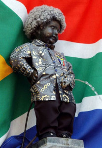 In honor of the 10th anniversary of the end of Apartheid and in honor of former South African President Nelson Mandela, the statue of Manneken Pis in Brussels, Tuesday April 27, 2004, was dressed with a Mandela outfit including the African shirt and a wig. (AP Photo/Thierry Charlier)